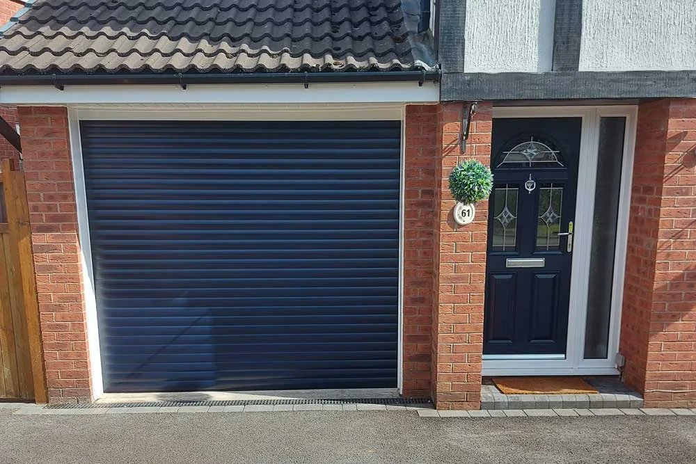 Dark blue roller garage door with matching front door