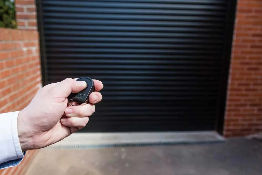 Remote-controlled black roller garage door